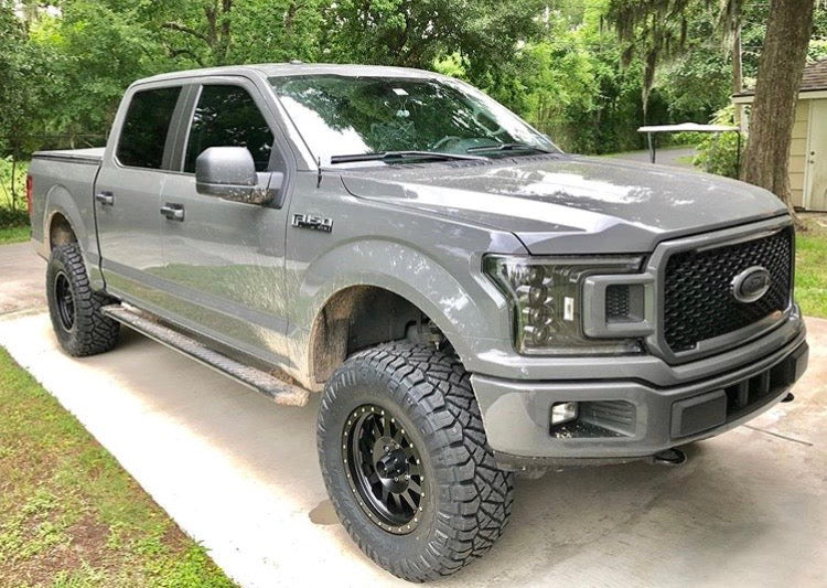 Lifted truck on off-road terrain showcasing performance upgrades