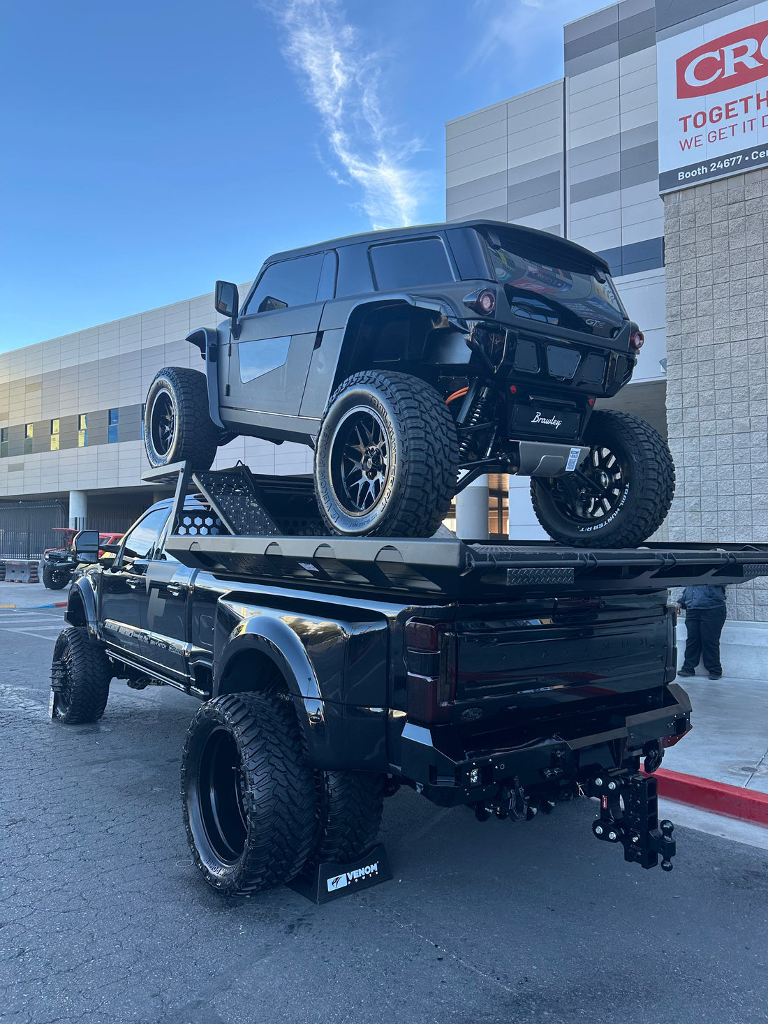 Jeep Wrangler with aftermarket lift kit and off-road tires on trail